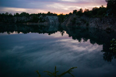 Scenic view of lake against sky at sunset