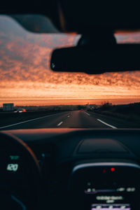 Car moving on road seen through windshield