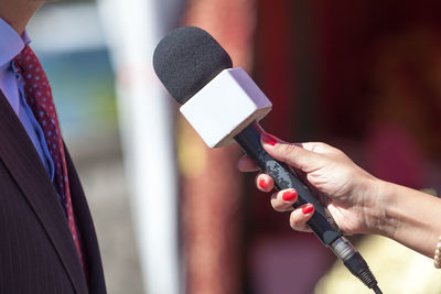 Cropped hand holding microphone