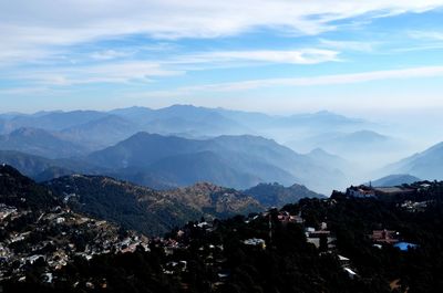 Scenic view of mountains against cloudy sky