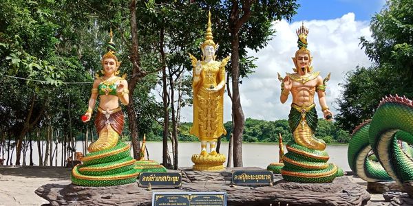 Statue of buddha against trees