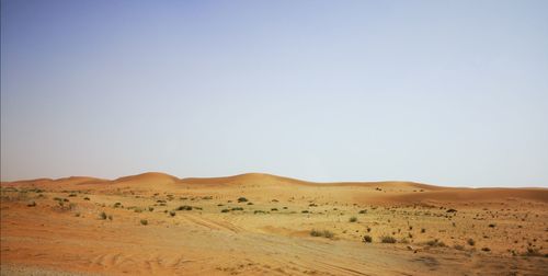 Scenic view of desert against clear sky