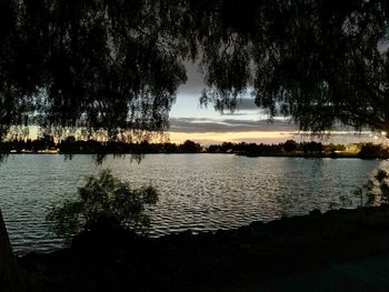 Scenic view of lake against sky at sunset