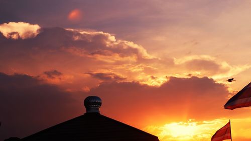 Low angle view of silhouette building against sky during sunset