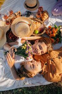 Summer party, outdoor gathering with friends. two young women, friends at the picnic having fun on