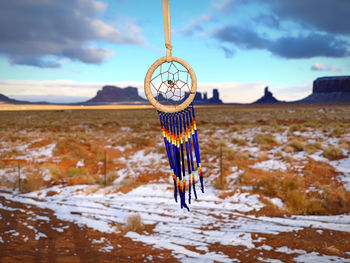 Dreamcatcher hanging with a panoramic view of monument valley behind