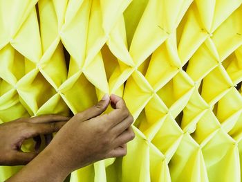 High angle view of woman holding yellow umbrella