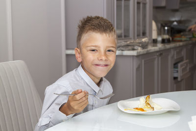 Portrait of boy eating food