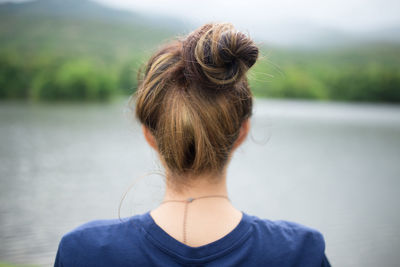 Rear view of woman looking at camera