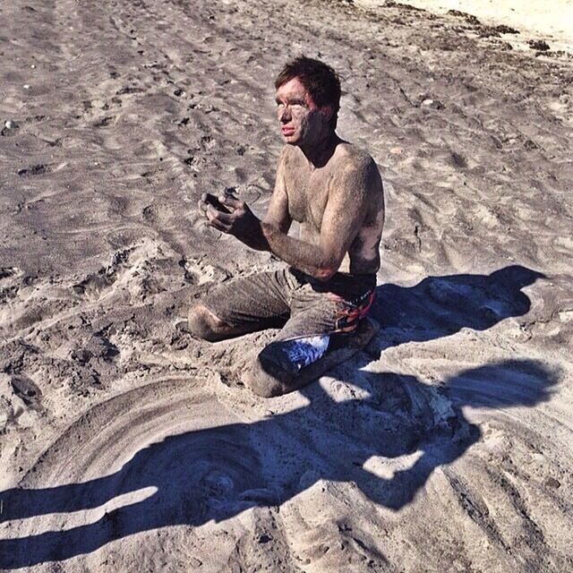 lifestyles, leisure activity, full length, person, sand, beach, casual clothing, vacations, rock - object, young adult, high angle view, young men, smiling, happiness, standing, nature, day, front view