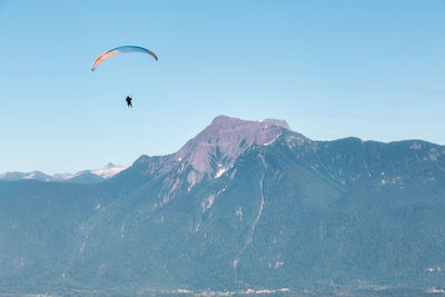 Person paragliding against sky