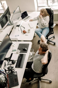 High angle view of people working on table