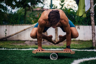 Full length of shirtless man exercising