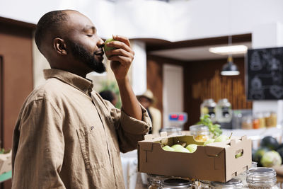 Side view of man drinking glass