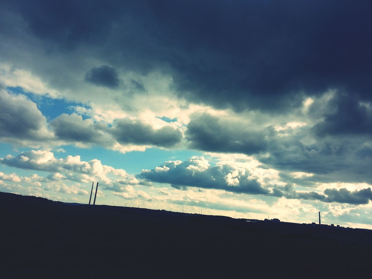 silhouette, sky, cloud - sky, low angle view, cloudy, cloud, beauty in nature, nature, dusk, built structure, tranquility, dark, scenics, tranquil scene, weather, outline, outdoors, building exterior, architecture, overcast