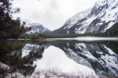 Scenic view of lake and snowcapped mountains against sky