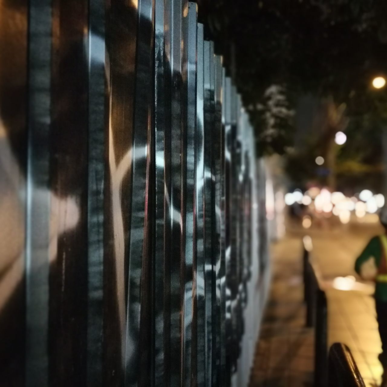 CLOSE-UP OF ILLUMINATED BLURRED MOTION OF PEOPLE AT NIGHT