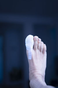 Cropped hand of woman holding dentures