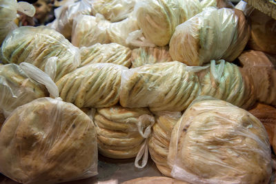 Pita bread in nylon bags and bakery goods in jerusalem old city market, israel