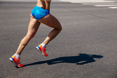 Midsection of man running on road