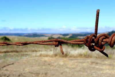 Close-up of padlock on chain against sky