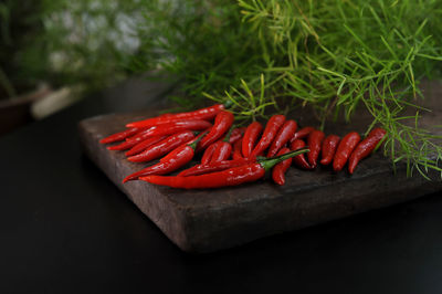 High angle view of red chili peppers on cutting board