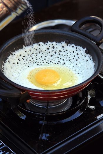 Egg in frying pan on stove