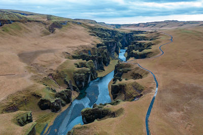 Wide estuary between hills in iceland, winding blue river, stream. tourist picturesque landscape.