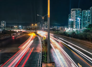 High angle view of light trails on road at night