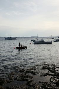 Scenic view of boats in sea against sky