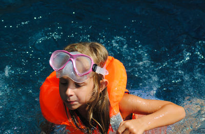 Portrait of girl swimming in pool