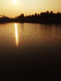 Scenic view of lake at sunset