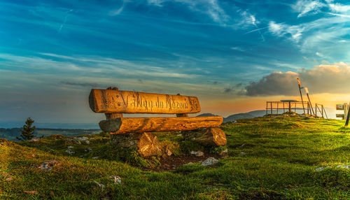 Illuminated information sign in sea against sky