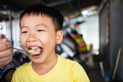 Portrait of boy eating food