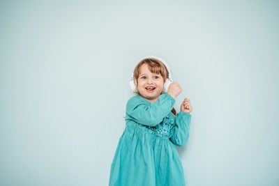 Portrait of smiling boy against blue background