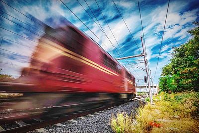 Railroad track against cloudy sky