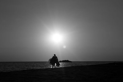 People on beach against sky