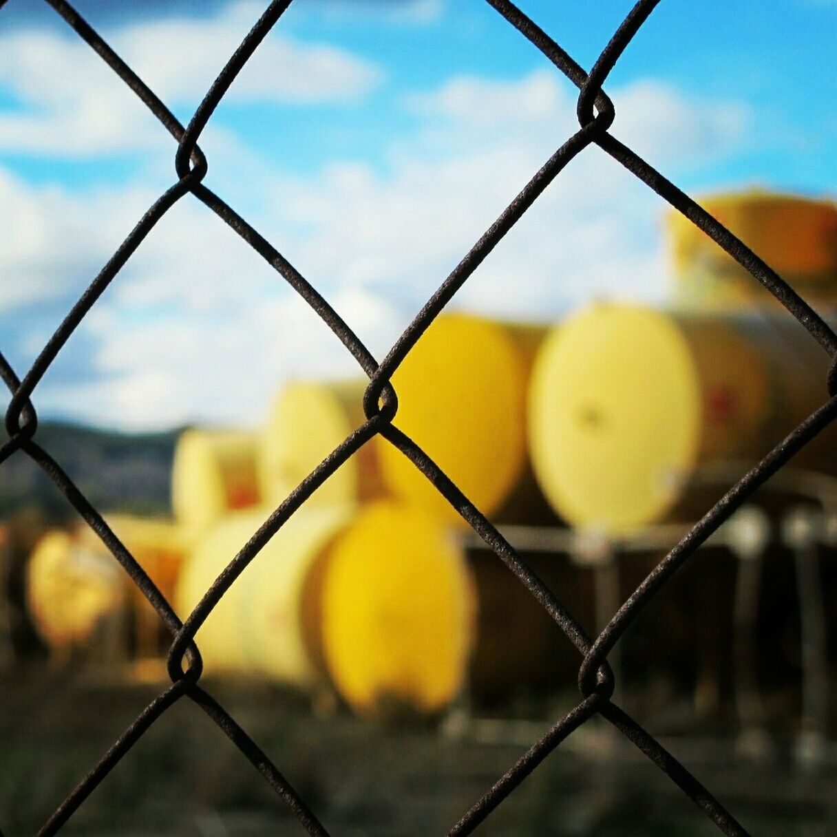 chainlink fence, protection, safety, fence, focus on foreground, security, yellow, metal, sky, close-up, full frame, pattern, backgrounds, outdoors, no people, day, sunset, nature, forbidden, cloud - sky