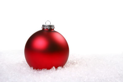 Close-up of christmas ornaments on snow