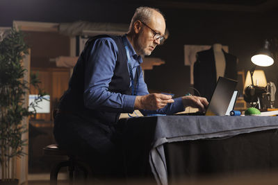 Young man using digital tablet while sitting at home