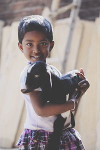 Portrait of smiling boy standing outdoors