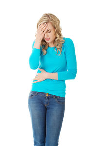 Young woman standing against white background