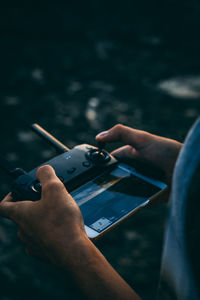 Midsection of man using mobile phone