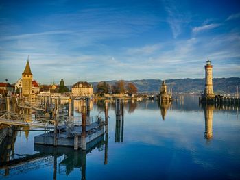 Scenic view of lake by building against sky