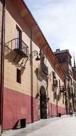 Street amidst buildings in town against sky