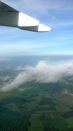 Cropped image of airplane flying over landscape