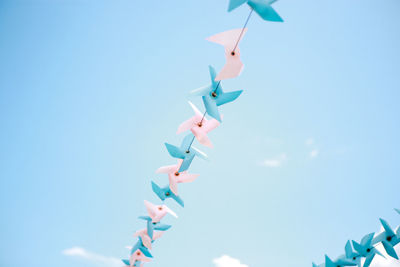 Low angle view of toys against blue sky