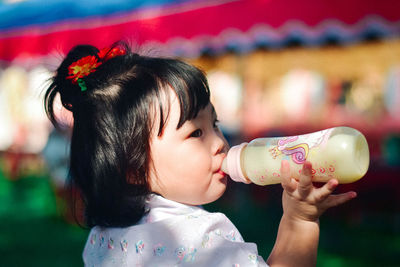 Side view of woman drinking water