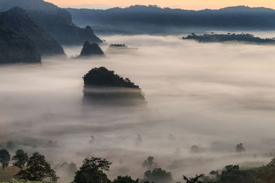 Scenic view of mountains against cloudy sky