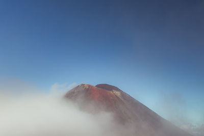 View of volcanic mountain against blue sky